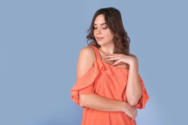 Free photo elegant lady in orange blouse