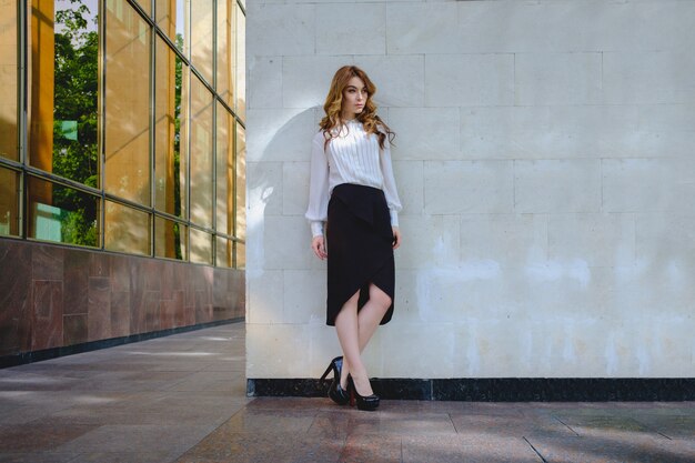 Elegant lady walking alone in the street