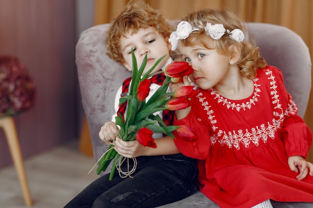 Elegant little kids with bouquet of tulip