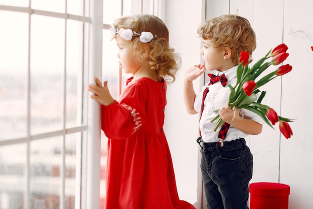 Elegant little kids with bouquet of tulip