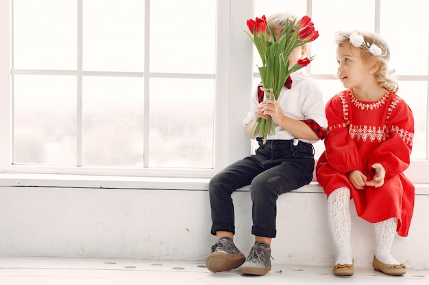 Elegant little kids with bouquet of tulip