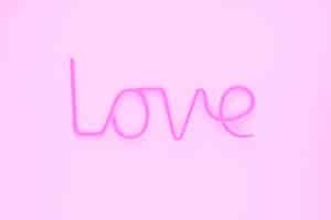 Free photo elegant love writing on pink