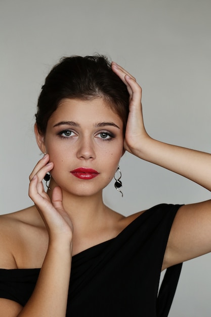 Elegant lovely woman posing with black dress