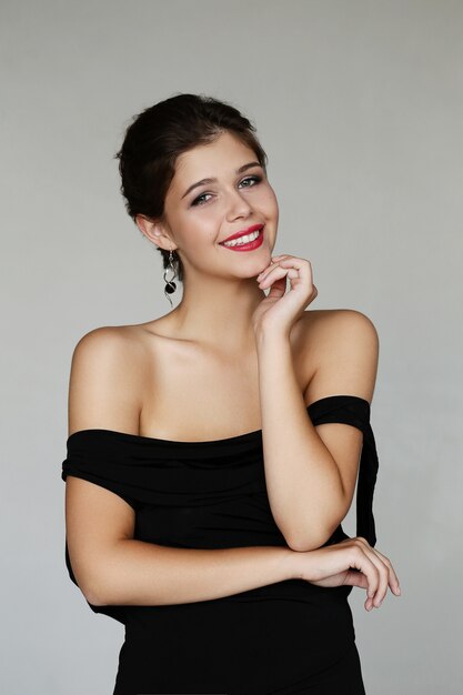 Elegant lovely woman posing with black dress