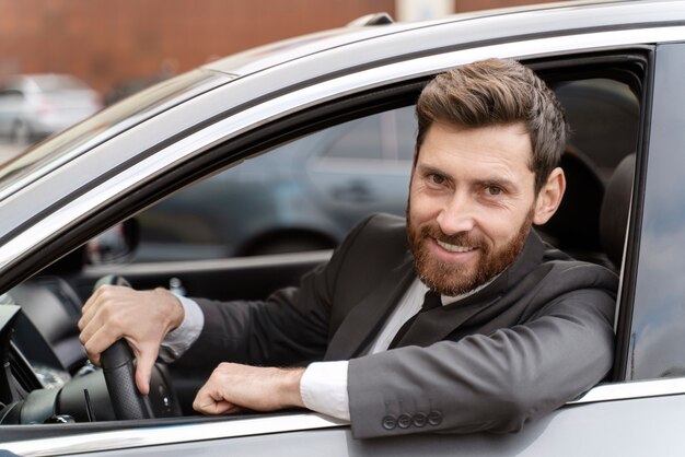 Elegant male taxi driver in costume