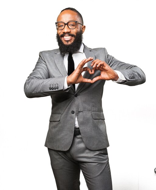 Elegant man making a heart with his hand