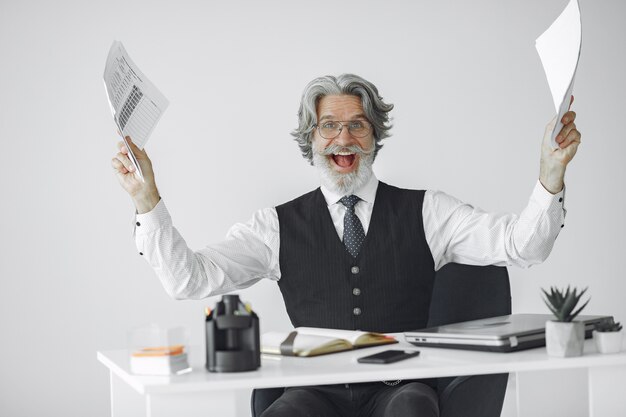 Elegant man in office. Businessman in white shirt. Man works with documents.