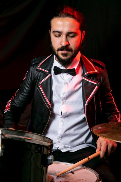 elegant man playing on drum set