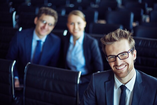 Elegant manager with colleagues background