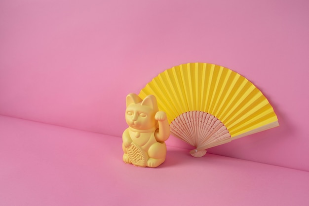 Elegant maneki neko statue with fan