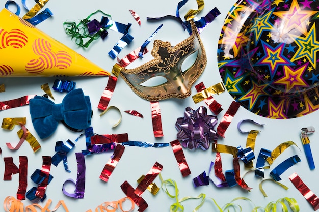 Elegant mask amidst party stuff