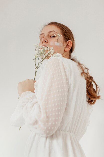 Elegant model holding flowers low angle