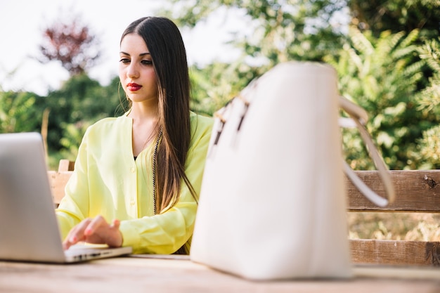 Elegant model with laptop in park