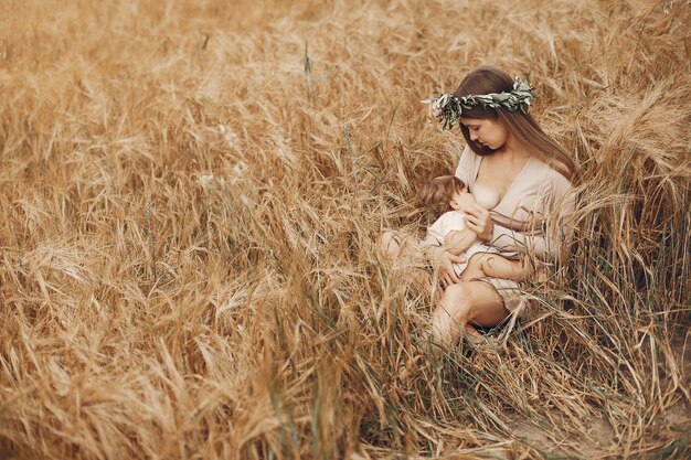 Elegant mother with cute little daughter in a field