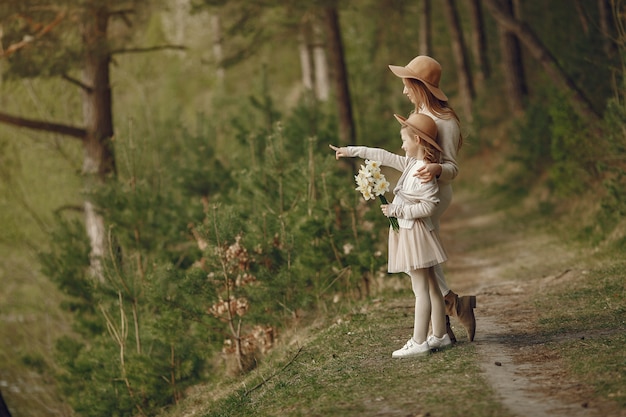 Elegant mother with daughter in a summer forest