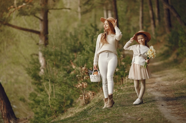 Elegant mother with daughter in a summer forest