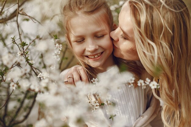 Elegant mother with daughter in a summer forest