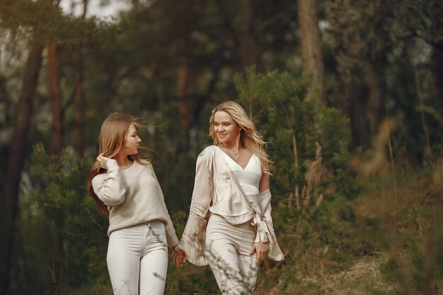 Elegant mother with daughter in a summer forest