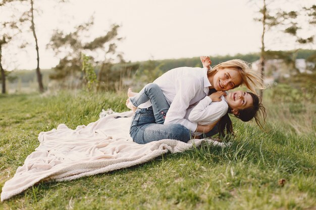 Elegant mother with daughter in a summer forest