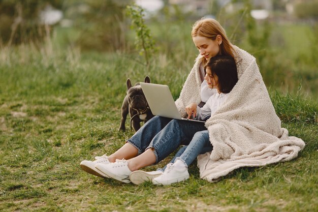 Elegant mother with daughter in a summer forest