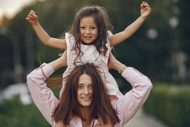 Elegant mother with daughter in a summer park