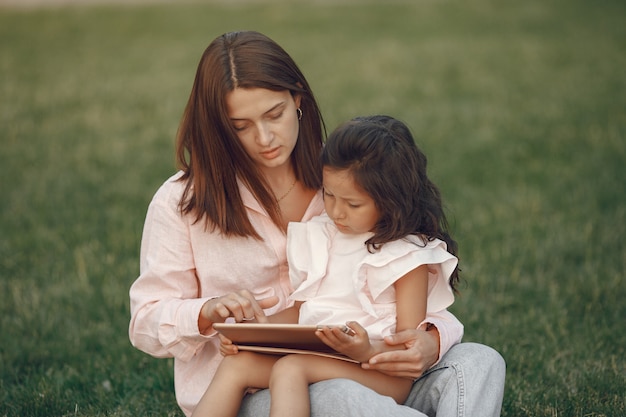 Elegant mother with daughter in a summer park