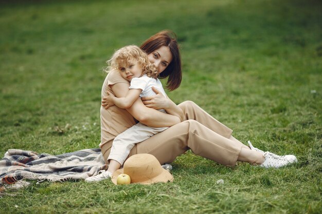 Elegant mother with daughter in a summer park