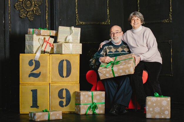 An elegant old couple are celebrating Christmas