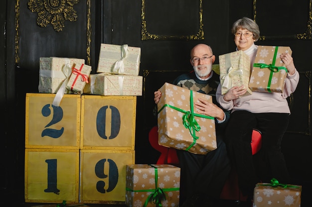 An elegant old couple are celebrating Christmas