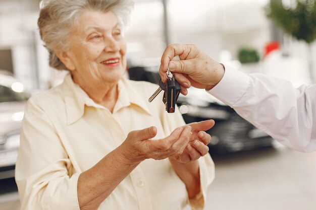 Elegant old couple in a car salon