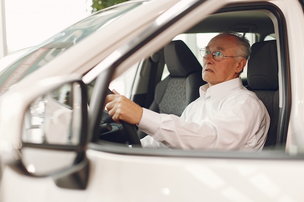 Free photo elegant old man in a car salon