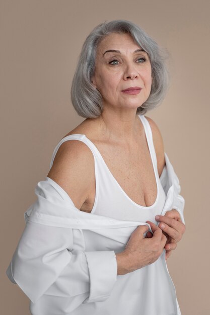 Elegant old woman wearing white clothes