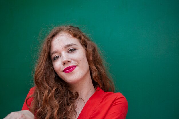 Elegant redhead woman looking at camera