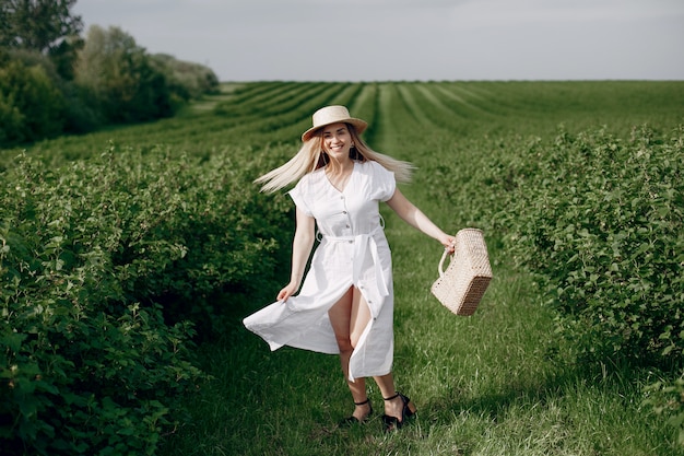 Elegant and stylish girl in a summer field