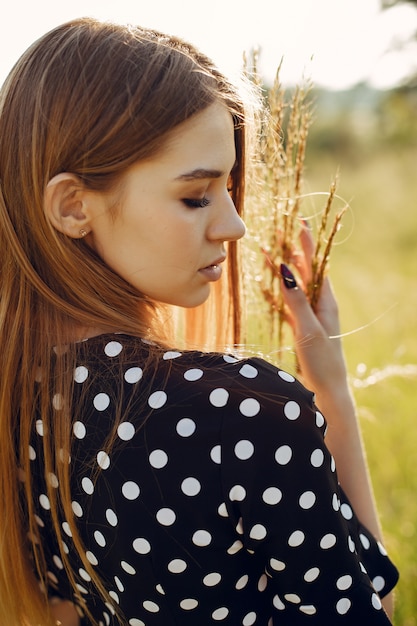 Elegant and stylish girl in a summer garden