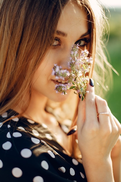 Elegant and stylish girl in a summer garden