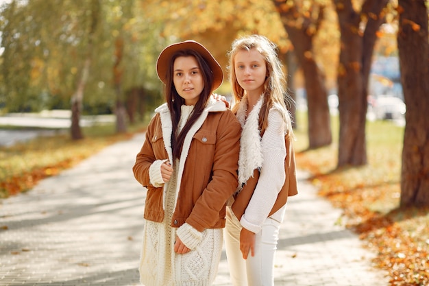 Elegant and stylish girls in a autumn park