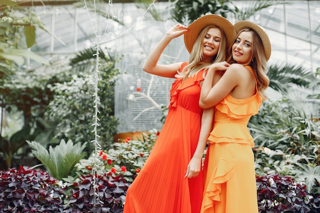 Elegant and stylish girls in a greenhouse