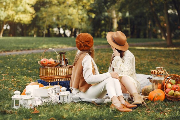 Elegant and stylish girls sitting in a park