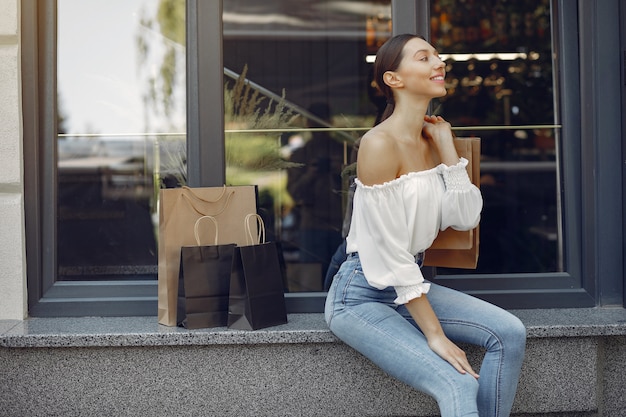 Elegant and stylish girls in the street with shopping bags