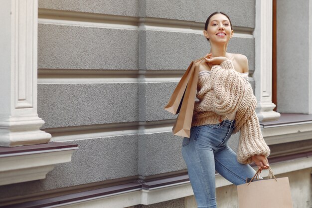 Elegant and stylish girls in the street with shopping bags