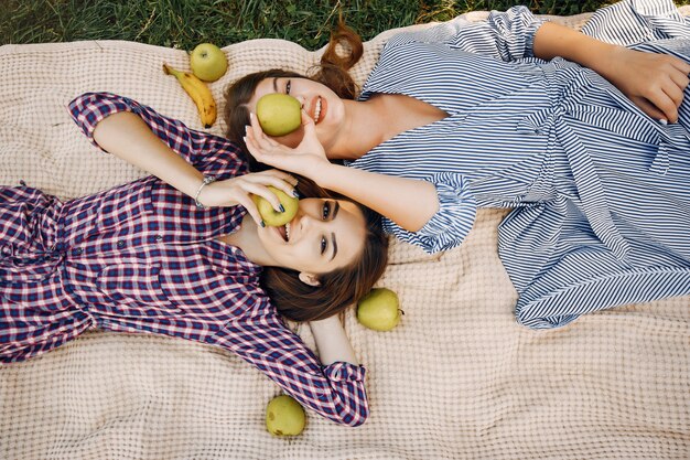 Elegant and stylish girls in a summer park