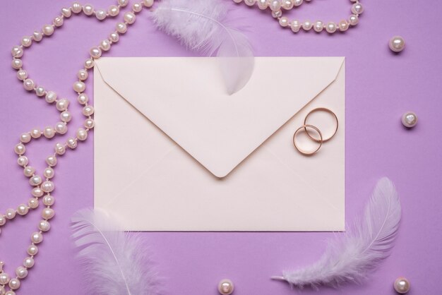 Elegant wedding rings with pearls on the table