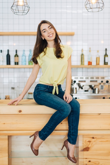 Free photo elegant woman on bar counter