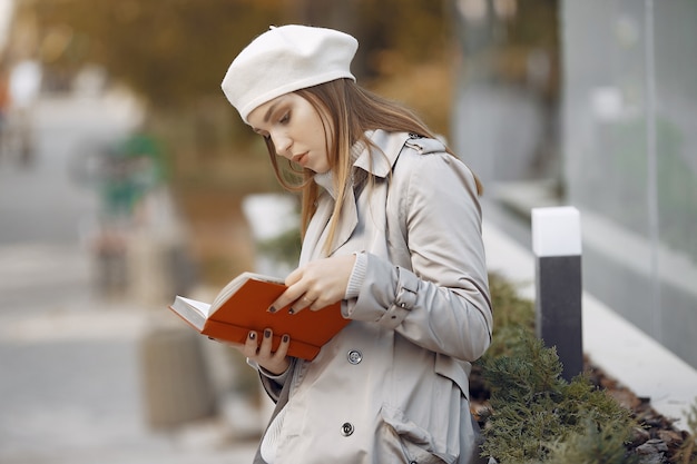 Elegant woman in a brown coat in a spring city