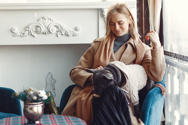 Elegant woman in a brown coat with black bulldog