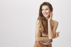 elegant woman laughing and flirty looking left