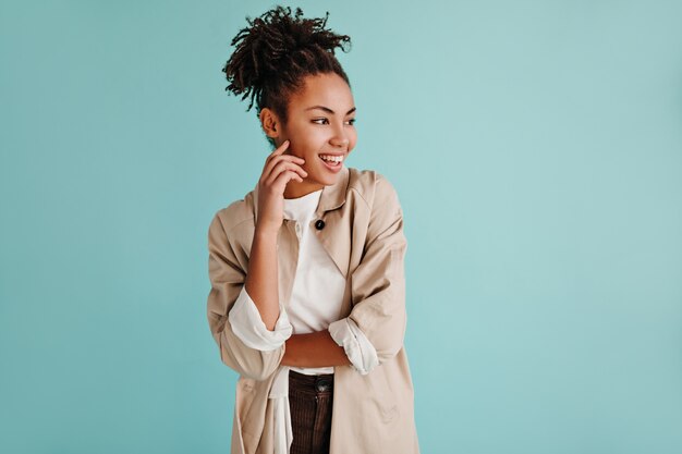 Elegant woman posing in beige trench coat