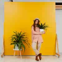 Free photo elegant woman posing with pots of plants