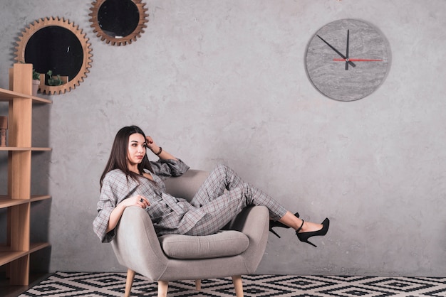 Elegant woman resting in armchair